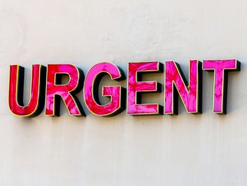 Bright pink 3D letters spelling 'URGENT' on a white background.