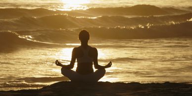 Woman meditating on beach