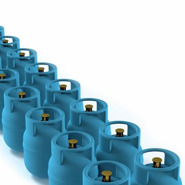 Rows of blue gas cylinders arranged diagonally on a white background.