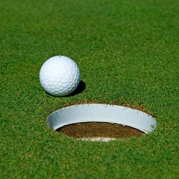 A golf ball near the hole