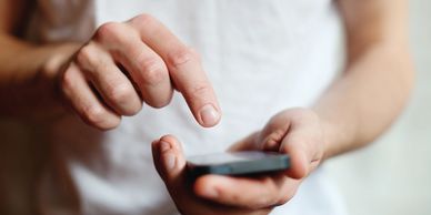 A picture of a man holding a mobile phone