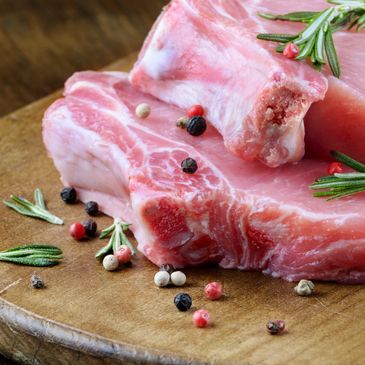 Two Meat Slices on a Wooden Bench 