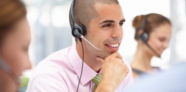 Smiling call center agent with headset.