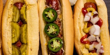 three hot dogs with various toppings