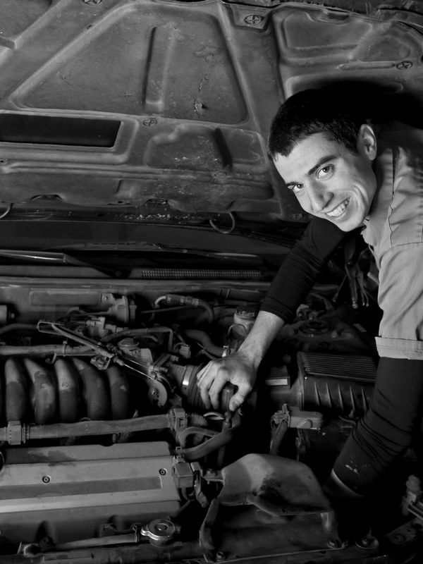 An associate working on a car that will serve a purpose in the life of a customer in the community.