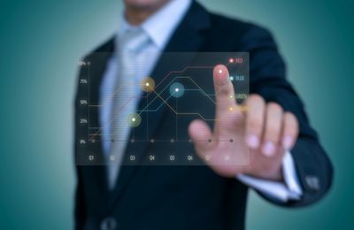 Businessman interacting with a futuristic digital chart interface.