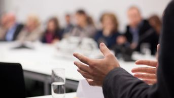 Hands of a person giving a talk in a boardroom