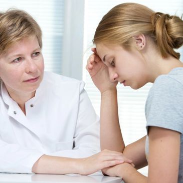 A doctor comforting a distressed patient during a consultation.