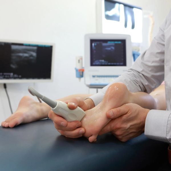 Practitioner scanning patient's foot.
