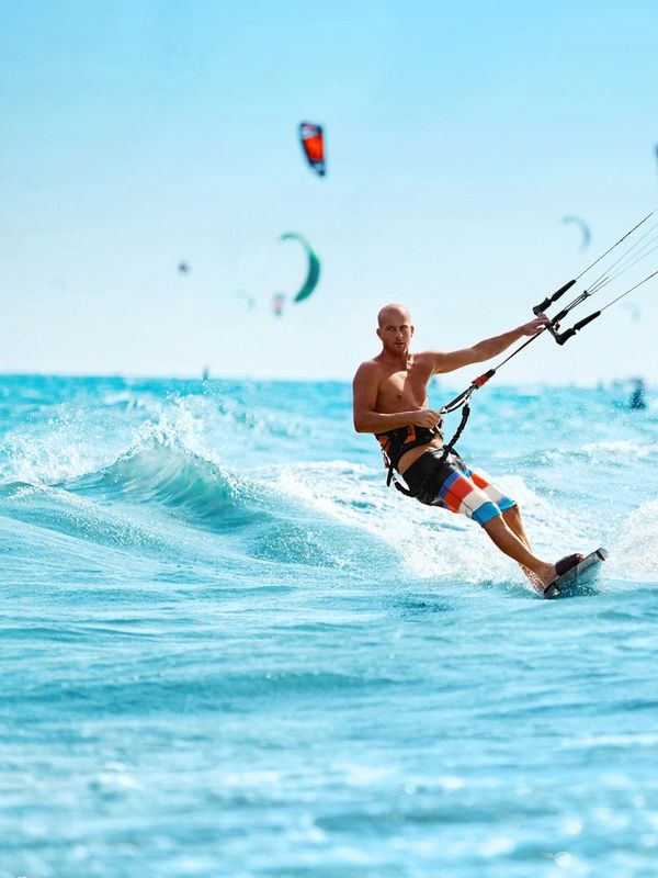 Man kite surfing on the ocean.