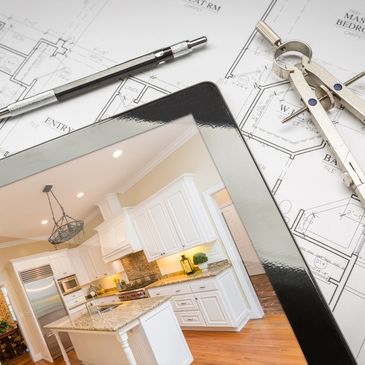 A tablet laying on schematical drawings with a white kitchen on the screen.