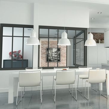 Modern white dining area with large pendant lights.