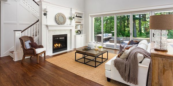 Bright living room with fireplace and large sliding glass doors.