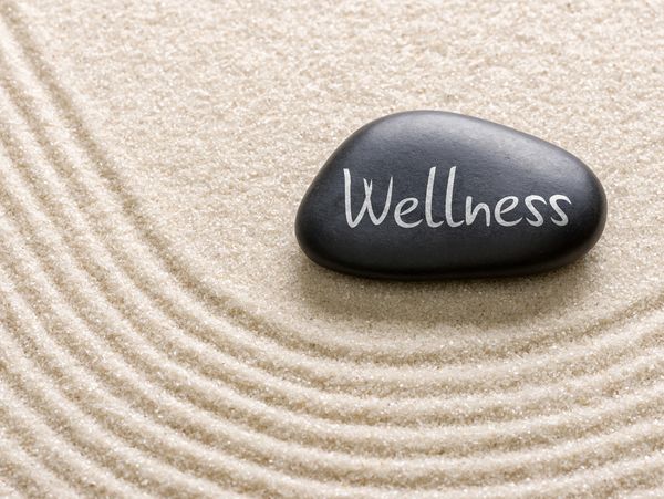 A black color stone with the text Wellness 