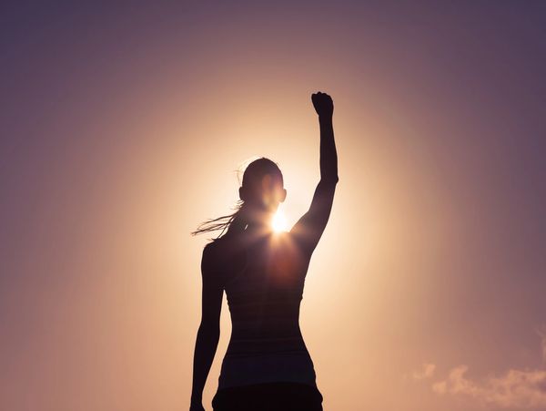 A picture of a woman making a power pose