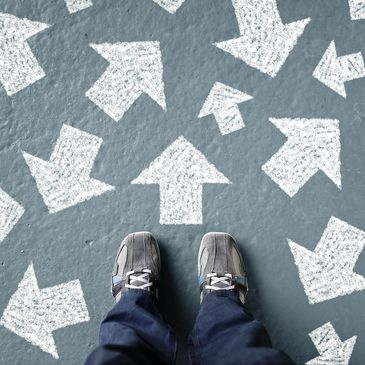 Person standing looking at arrows on the ground