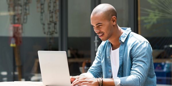 a black man smiling while having a mindfulness session with nicole. 