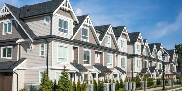 Row of modern townhouse units on a sunny day.