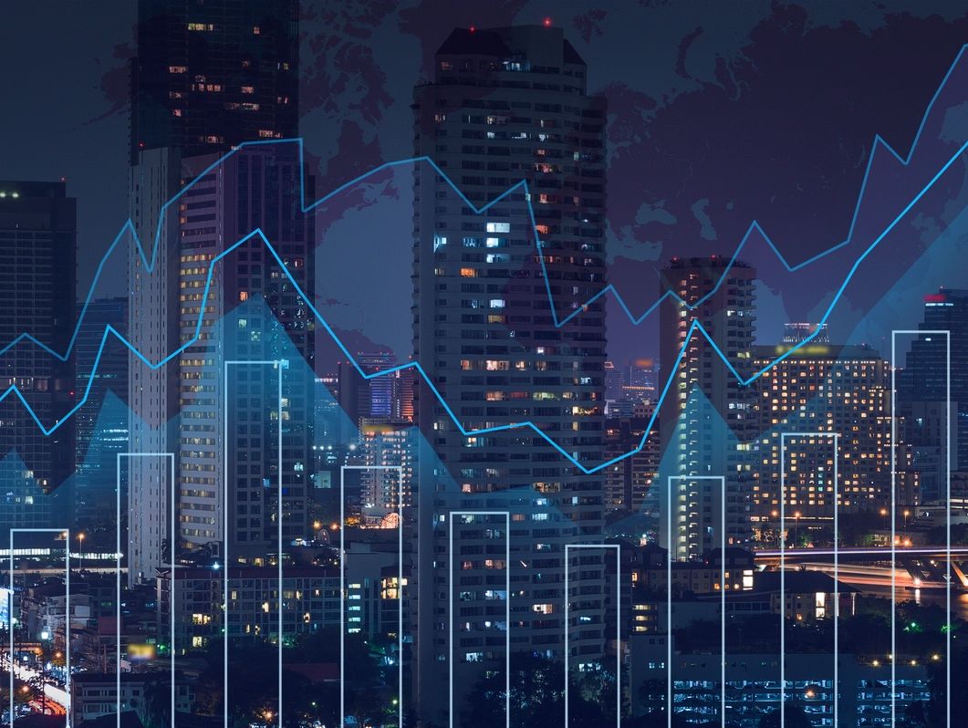 An image of a cityscape overlaid with economic growth charts.