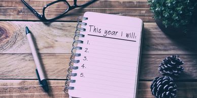 A small notebook that says, "This year I will:"