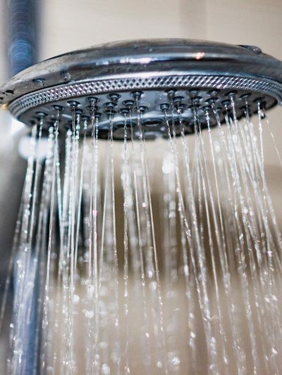 Close-up of water flowing from a showerhead.
