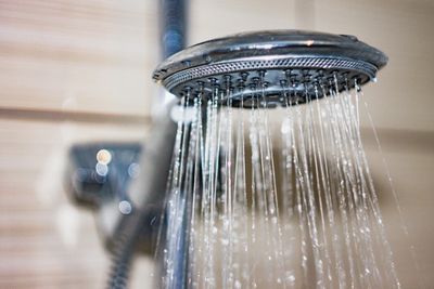 Close-up of water flowing from a showerhead.