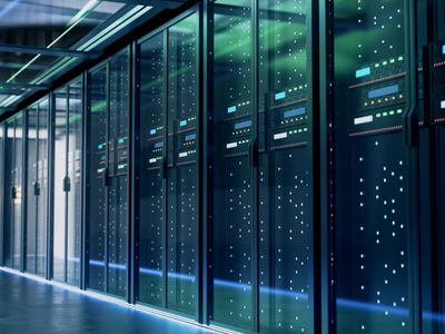 A modern data center corridor with server racks and blue LED lights.