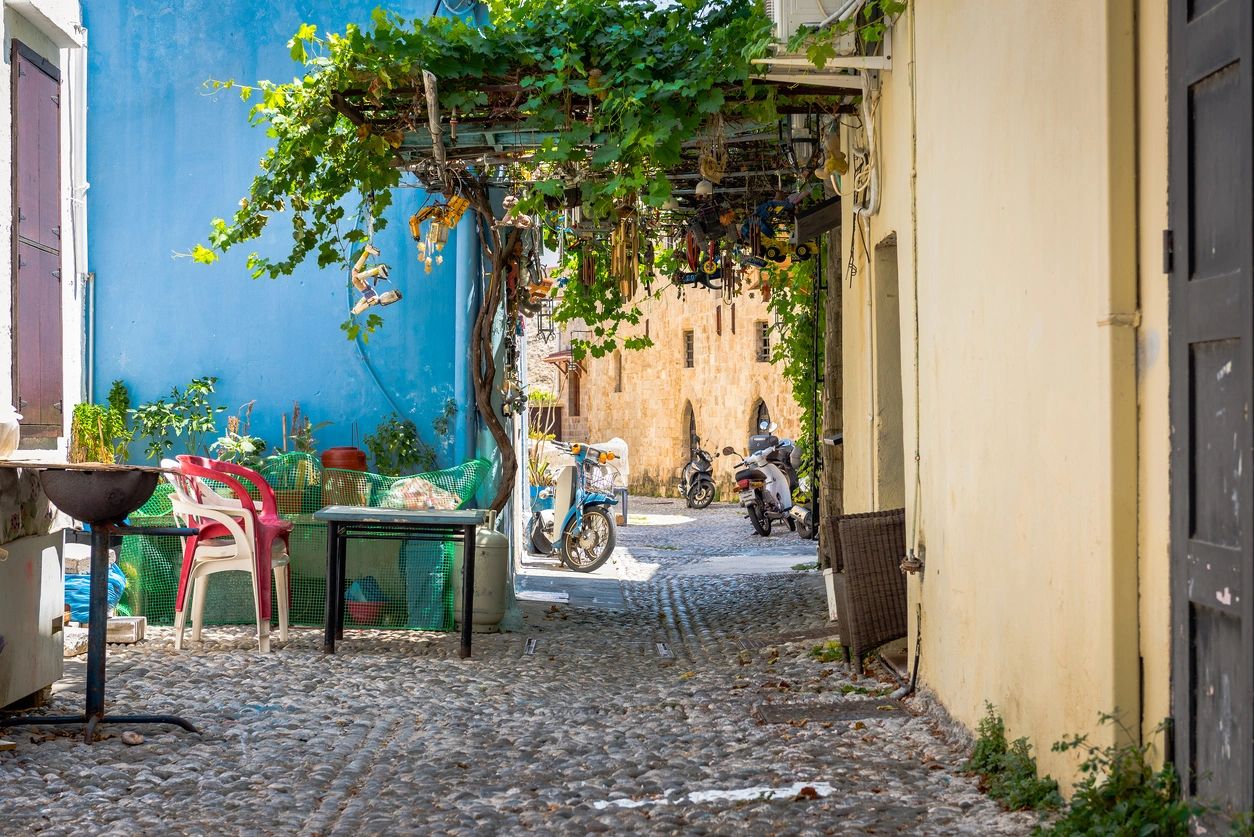 Cobblestone alley in a European village — the kind of place Abroad readers call home.