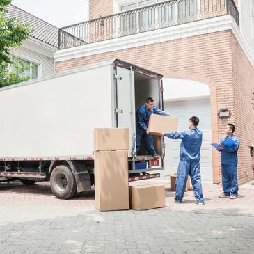 Group of people loading the carton boxed into van