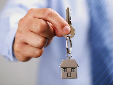 a man holding the keys to a house.