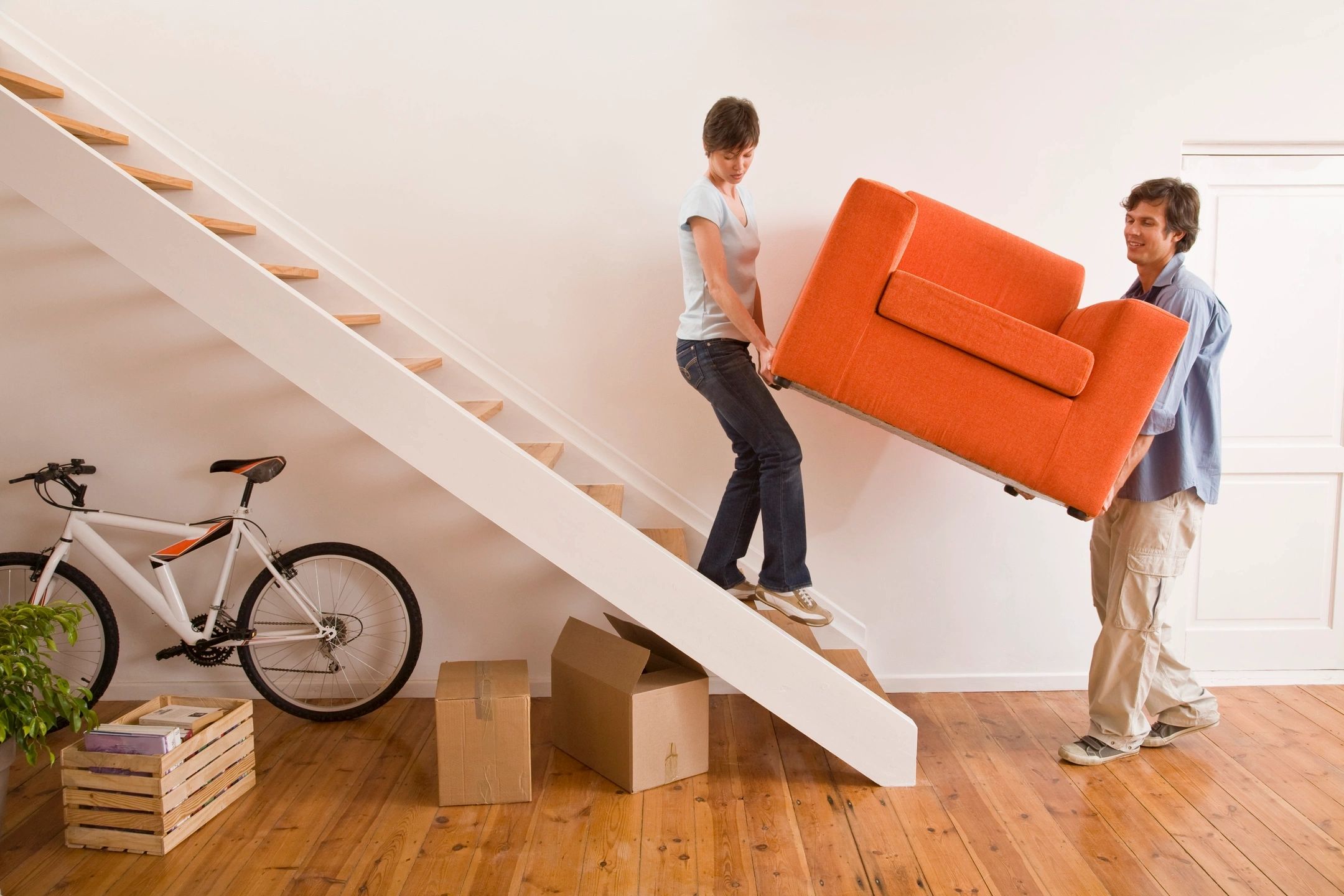 a couple moving out a chair from their home