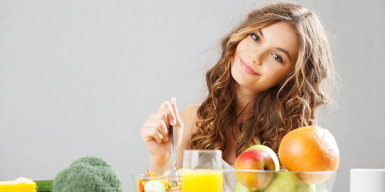 women looking at the camera eating fruits