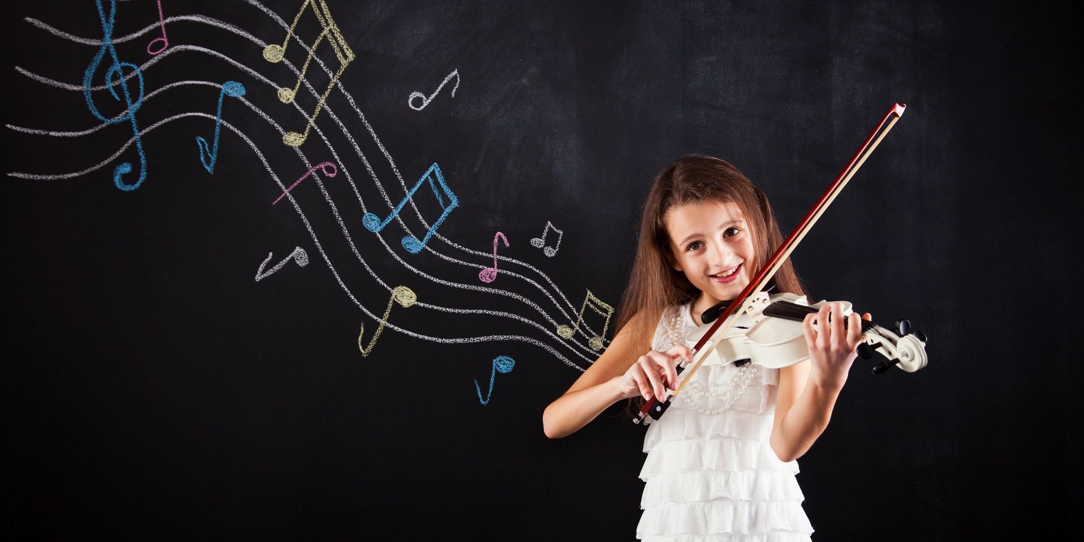 Girl playing violin with colorful music notes on a chalkboard.