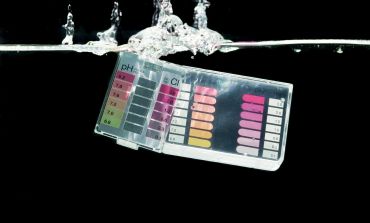 Water test strips immersed in water splash.
