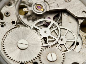 Close-up of metallic gears in a mechanical watch movement.