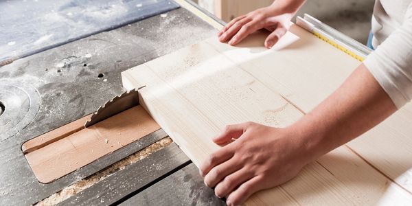 Woodworking builder cutting wood for customized gifts.