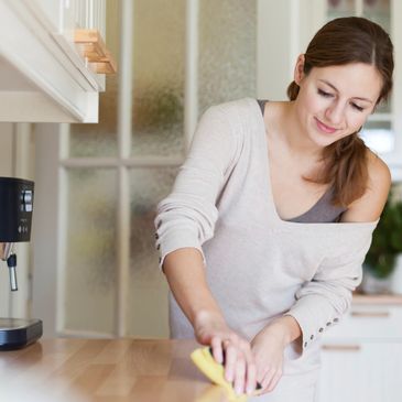 Woman wiping down a kitchen counter