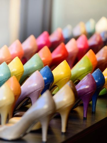 Colorful high-heeled shoes arranged in rows.