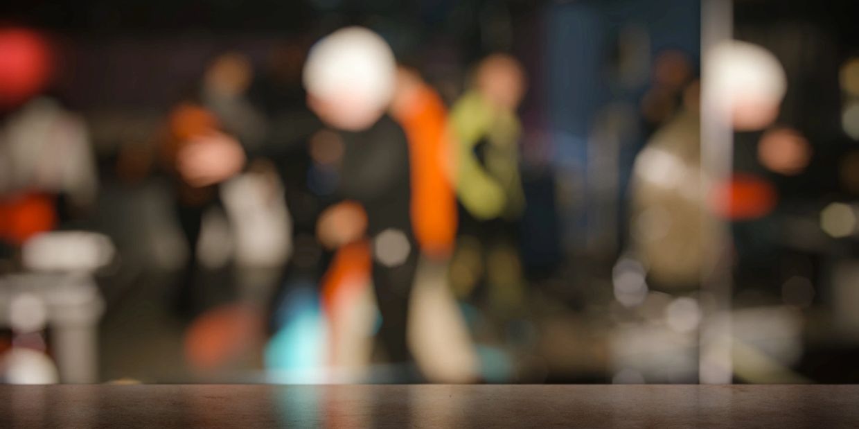 Blurry people in the background of the shot. Toxic work environment. Career journey. 