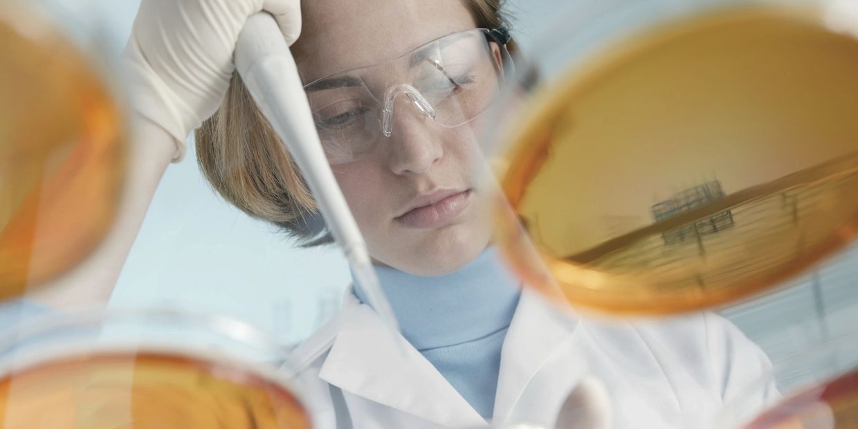 Lab technician testing in agar plate for regulatory compliance