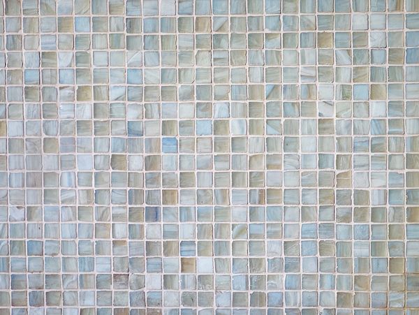 Close-up of blue and beige mosaic tiles arranged in a grid pattern.