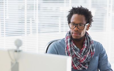 man sitting at computer for teletherapy session