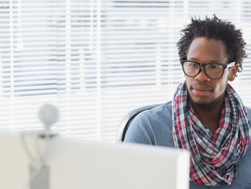 Man working at a computer in an office.