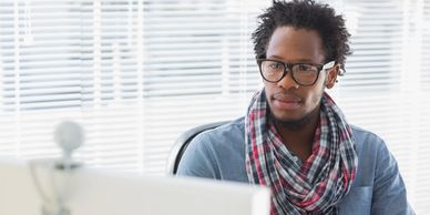 a man looking at his computer during a video call