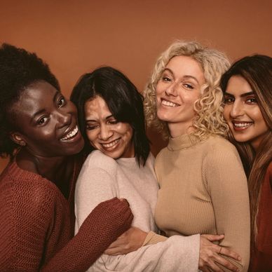 4 women hugging and smiling