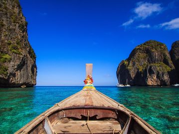 Front of the canoe pointing toward the ocean with cliffs on either side.