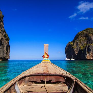 Boat floating on clear blue water