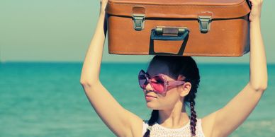 Happy female carrying a suitcase