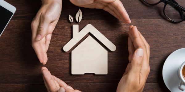 Hands surrounding a home symbolizing the company's mission and company values.