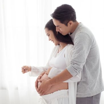 Expecting parents celebrating pregnancy after seeking a reproductive therapist in Denver, CO